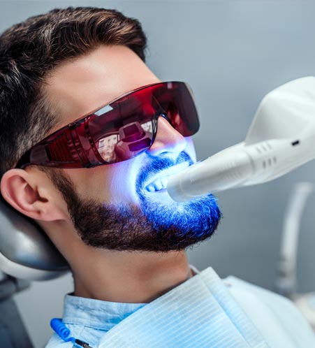 Patient undergoing teeth whitening procedure